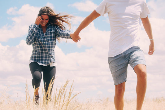 Happy Couple Walking Outdoors Together Enjoying The Healthy Benefits That Come From A Daily Walk