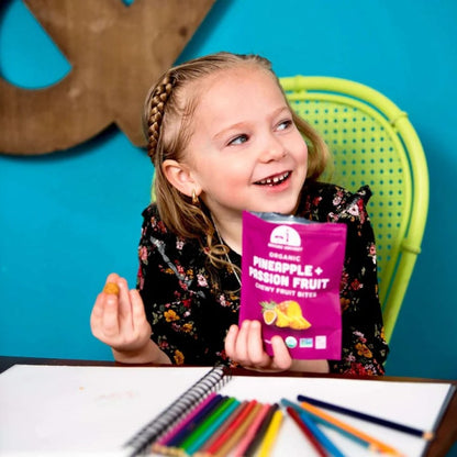 Young Girl Eating Healthy After School Snack Food Organic Mavuno Harvest Pineapple Passionfruit Bites