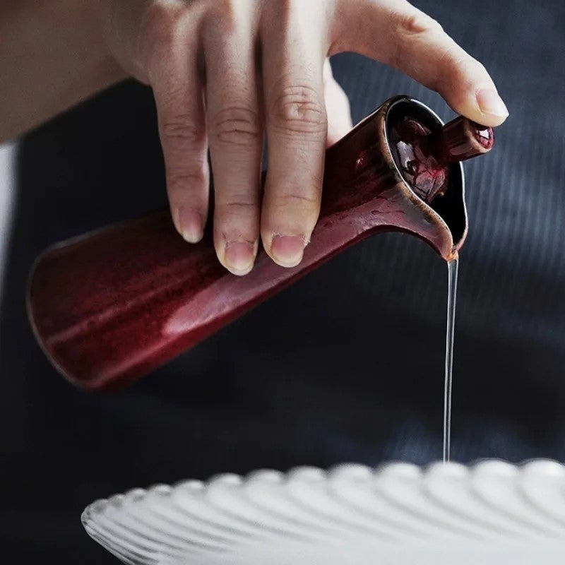 Pouring Liquid Out Of Merlot Red Ceramic Bottle With Lid Terrace Cruet