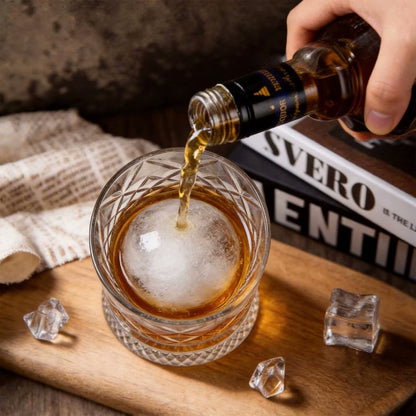 Pouring Liquor In Drinking Glass With Baller Ice In Spinning Tumbler Cup