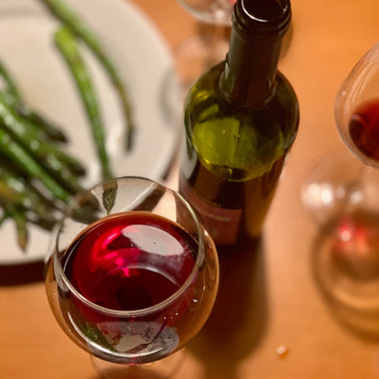 Wine Bottle And Glasses Of Red Wine On Table With Dinner